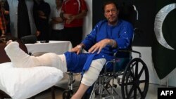 Former Pakistani Prime Minister Imran Khan speaks with reporters from a hospital in Lahore on November 4, a day after an assassination attempt on him during a march near Wazirabad.