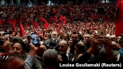 Njerëzit bëjnë fotografi të kryeministrit të Shqipërisë, Edi Rama, teksa ai mbërrin në një stadium para emigrantëve shqiptarë, në Athinë, Greqi, 12 maj 2024.