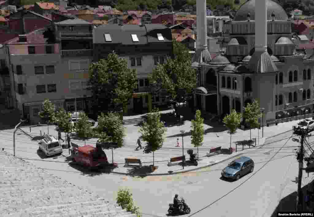 Rahovec 10 korrik 1999: Mijëra qytetarë kishin dalë këtë ditë në qendër të qytetit në Rahovec në ditën e katërt të protestës kundër një dislokimi të mundshëm të trupave paqeruajtëse ruse. Qytetarët shqiptarë të Rahovecit kishin protestuar për disa ditë duke thënë se paraushtarakët rusë kishin marrë pjesë në dhunën serbe kundër tyre. 6 qershor 2024: Përveçse është zvogëluar hapësira e sheshit, xhamia është rrënuar dhe ndërtuar një e re. Disa objekte që shihen para 25 vjetësh ende janë aty, vetëm se kanë pamje tjetër të jashtme.