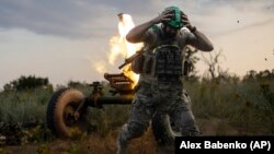 A Ukrainian soldier of the 3rd Separate Assault Brigade fires a 122mm mortar toward Russian positions at the front line near Bakhmut on July 2.