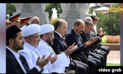Myftiu Nuriddin Kholiqnazarov (i treti majtas) presidenti Shavkat Mirziyoev, dhe kryeministri Abdulla Aripov në një paraqitje publike në Tashkent më 31 gusht.