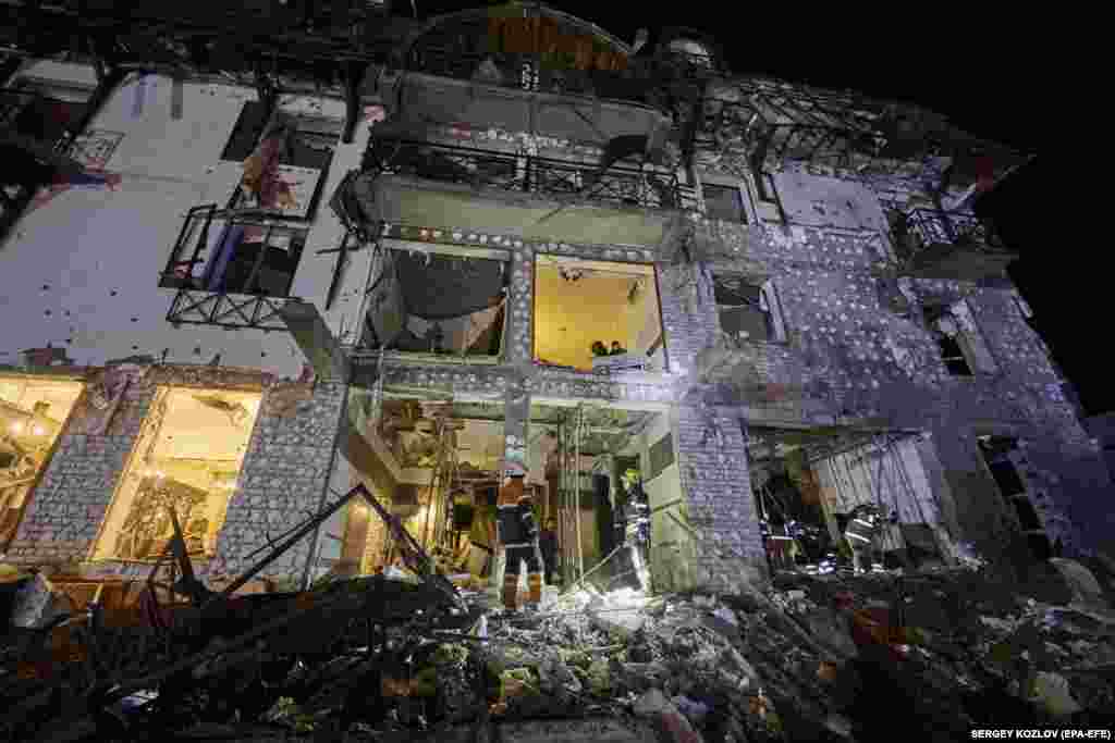 Ukrainian rescue personnel work at the site of a Russian missile attack on a hotel in Kharkiv late on January 10 that wounded 11 people, according to local authorities. The strike comes just weeks ahead of the war's second anniversary, with both Moscow and Kyiv accusing each other of inflicting civilian casualties in a sharp escalation of attacks.