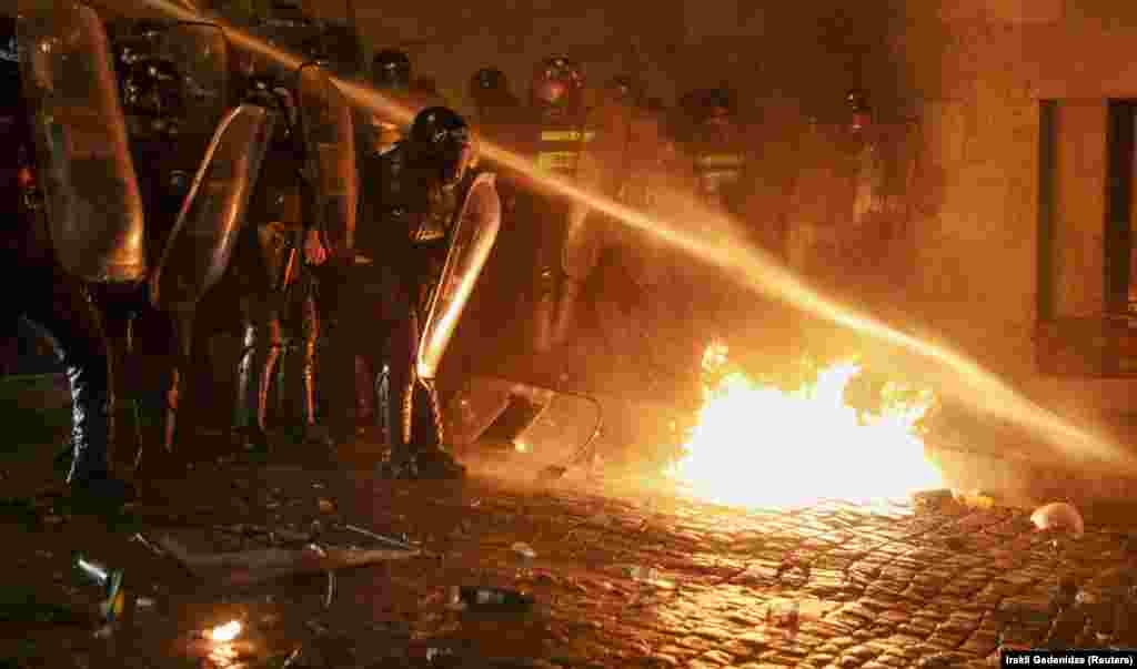 O bombă incendiară este stinsă cu tunul cu apă. 