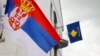 Flamuri serb, majtas, valëvitet në një shtyllë dritash ndriçimi përpara flamurit të Kosovës në objektin e Komunës së Zubin Potokut, Kosovë, 31 maj 2023.