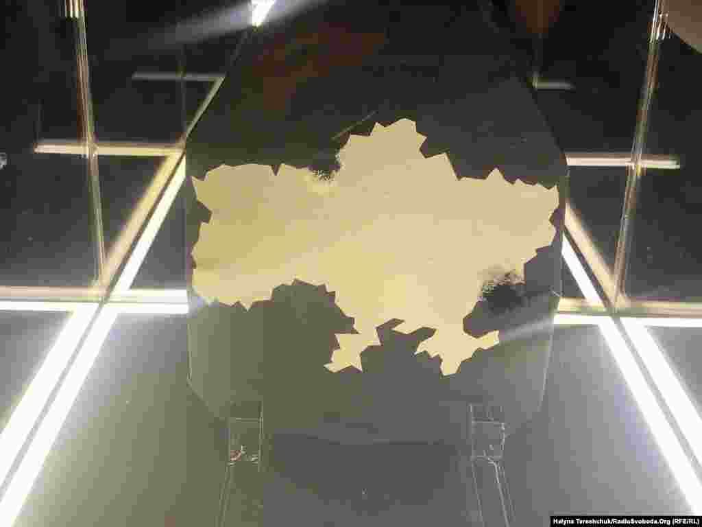A battle-damaged Kevlar plate with a map of Ukraine. Organizers of the exhibition say they intend to raise money from the sale of the artworks to purchase more body armor for Ukrainian troops. 