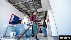 Workers clean offices in the building of the Kurdistan24 broadcaster, which was damaged in the missile attacks on March 13.