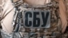 СБУ вказує на те, що після окупації Херсона Шпіра призначили «заступником міністра цифрового розвитку та масових комунікацій» у місцевій окупаційній адміністрації РФ