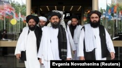 Members of a Taliban delegation, led by chief negotiator Mullah Abdul Ghani Baradar (center, front), leave after peace talks with Afghan senior politicians in Moscow on May 30, 2019.