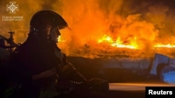 A firefighter works at a site that was hit during Russia's drone attacks in the Odesa region on September 3.