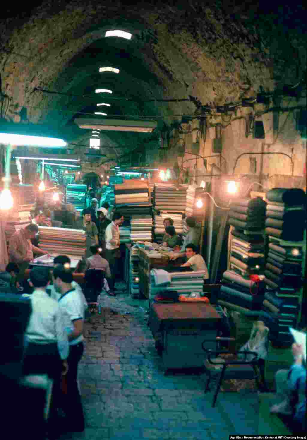 A souq in Aleppo photographed in the 1980s. With its position on the Silk Road, the great trade route linking Asia and Europe, Aleppo became a famed merchant center where almost anything from East or West could be bought. In the corridors of the souq, it was said, "Deals were more important than ideals."