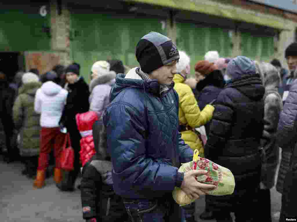 Біженець зі Східної України несе пакет з їжею з пункту волонтерської допомоги у Слов'янську, 7 лютого 2015 року