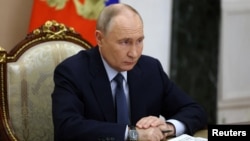 Russian President Vladimir Putin chairs a meeting with senior Defense Ministry officials, defense industry representatives and missile systems developers in Moscow on November 22.