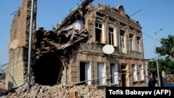 AZERBAIJAN -- A local man looks at a residential building damaged by shelling during the ongoing military conflict between Armenia and Azerbaijan over the breakaway region of Nagorno-Karabakh, in the city of Ganca, on October 27, 2020
