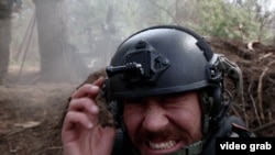 RFE/RL correspondent Maryan Kushnir reacts as Ukrainian forces fire artillery toward Russian positions near Kupyansk in the Kharkiv region. 