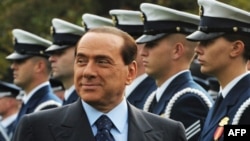 Italian Prime Minister Silvio Berlusconi inspects the honor guard during a welcome ceremony at the White House in October 2008.
