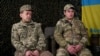 Ukraine - soldiers help their wounded comrades evacuate Chasiv Yar even as their own armored vehicle was hit fire in transit. screen grab