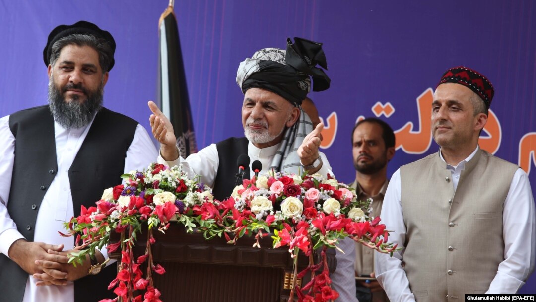 President Ashraf Ghani (center) stands with Amrullah Saleh (right), his vice presidential candidate, during his election campaign stop in Jalalabad on September 20.