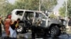 Pakistani security officials at the scene of a bomb attack that targeted a senior police officer in Peshawar on November 24.