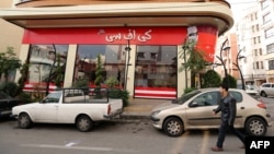 A man walks past the fried chicken shop Halal KFC, which Iranian authorities closed on November 3.