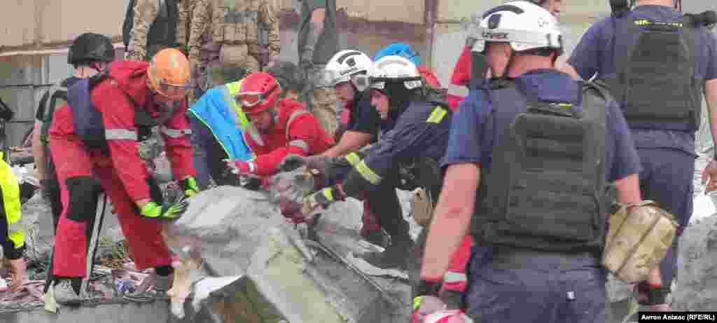 Rescuers removing rubble after the strike. Local authorities told media that "people are under the rubble" as rescue work was continuing. 