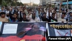 Angry protester chant slogans during a demonstration against independent Pakistani newspaper Dawn outside the Press Club in Karachi on December 3.