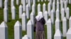 Një grua duke ecur mes varreve të viktimave të masakrës së Srebrenicës në Potoçari, pranë Srebrenicës.