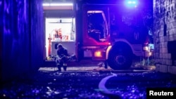 An emergency worker rests after fighting fires at an apartment building following a Russian drone attack in Kyiv on May 4.