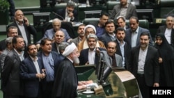 Iranian President Hassan Rohani (center) presents his budget bill to the country's parliament on December 25.