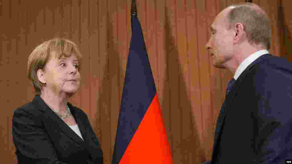 Russian President Vladimir Putin meets with German Chancellor Angela Merkel in Normandy on June 6, 2014, during events held to mark the 70th anniversary of D-Day. During the commemorations, the leaders of Russia, Ukraine, Germany, and France met informally in an attempt to resolve the war in Ukraine's Donbas region. Notably absent from the group was the United States. The talks led to the establishment of the Minsk Protocol later the same year.