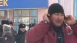 Человек в рабочей спецовке, рядом стоят полицейские. Жанаозен, 16 декабря 2011 года. Скриншот с видеопортала "Стан.кз". 
