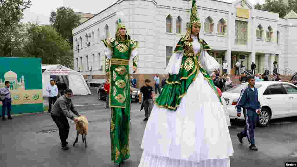Әртістердің жанында қой ұстап тұрған азамат. Алматы, 21 тамыз 2018 жыл 
