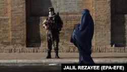 یو افغانه مېرمنه او یو طالب وسله وال. انځور- ارشیف