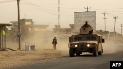 Afghan security forces travel in a Humvee vehicle to aid colleagues fighting Taliban militants in the northern city of Kunduz on September 28.