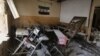 Syria -- A pre-Baath Syrian flag, now used by the Syrian opposition, hangs in a heavily damaged classroom after a barrel bomb hit a school in Syria's northern city of Aleppo Saif al-Dawla district, where control is split between the Syrian regime and opposition.