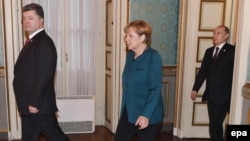 Президент України Петро Порошенко, канцлер Німеччини Ангела Меркель та президент Росії Володимир Путін під час зустрічі у «нормандському форматі» у Мілані. Жовтень 2014 року