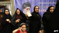 Iranian women cast their ballots for the presidential election at a polling station in southern Tehran on May 9.