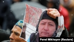 Дулат Ағаділдің суретін ұстап тұрған белсенді.