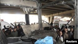 A bus is damaged after an explosion in the Maidan district of Damascus on January 6.