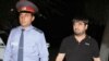 Armenia -- A policeman escorts Sevak Minasian, the arrested son of the deputy prosecutor of Armavir region, 26Sep2012.