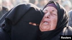 Mourners react near the bodies of Palestinians killed in Israeli air strikes in Khan Younis on January 17.