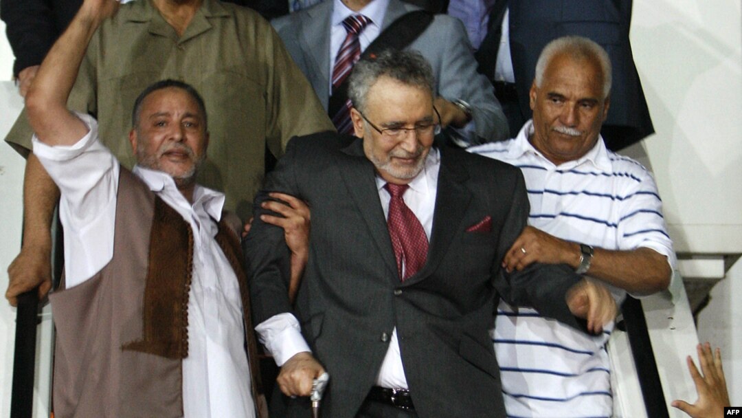 Convicted Lockerbie bomber Abdelbasset Ali al-Megrahi (center) was welcomed as a hero on his return to Tripoli after release by Scottish authorities on compassionate grounds in August 2009.