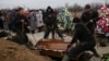 Ukraine -- People attend the funeral ceremony for Aleksandr Demyanenko who was killed during the 24 January shelling of the eastern Ukrainian city, in Mariupol, January 26, 2015