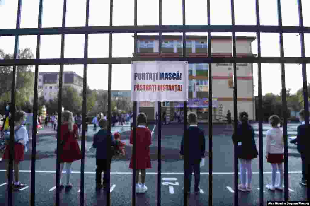Учні дотримуються соціальної дистанції на шкільному подвір'ї у Бухаресті (Румунія)