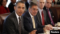 U.S. President Barack Obama (left) is flanked by Defense Secretary Leon Panetta as he speaks at a Cabinet meeting in Washington in late January.