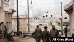 An undated photo from the Fars news agency shows Iranian Revolutionary Guards Forces during fighting in Aleppo, Syria. 